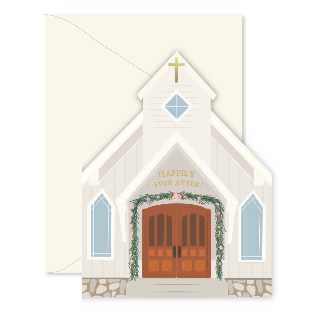 A die-cut church illustration card featuring a cream-colored chapel with a brown double door, green garland, and the words 'HAPPILY IVY ABBE' above the door, shown with a matching cream envelope behind it.